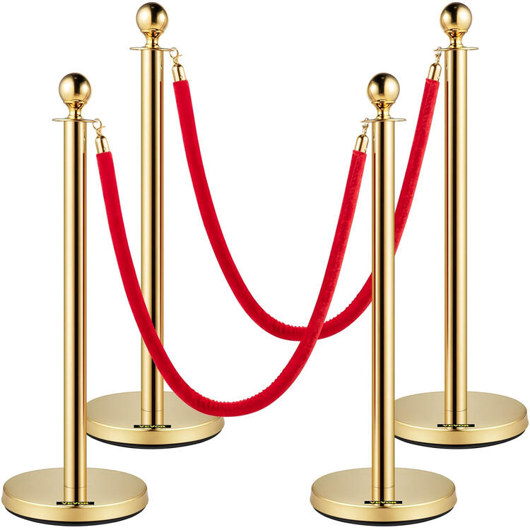 Gold stanchion posts with red velvet rope barrier Gold stanchion posts with red velvet rope barrier
