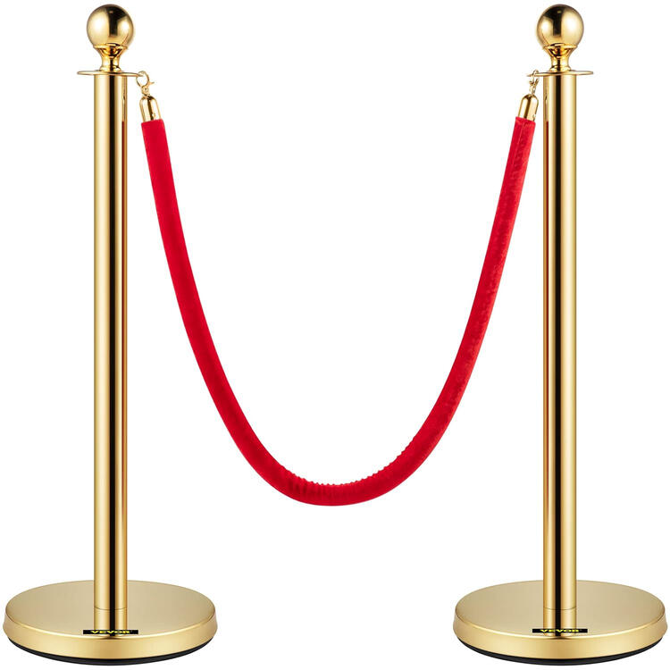 Gold stanchion posts with red velvet rope queue barrier Gold stanchion posts with red velvet rope queue barrier
